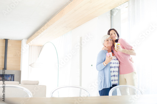 Mother and daughter having cup of coffee