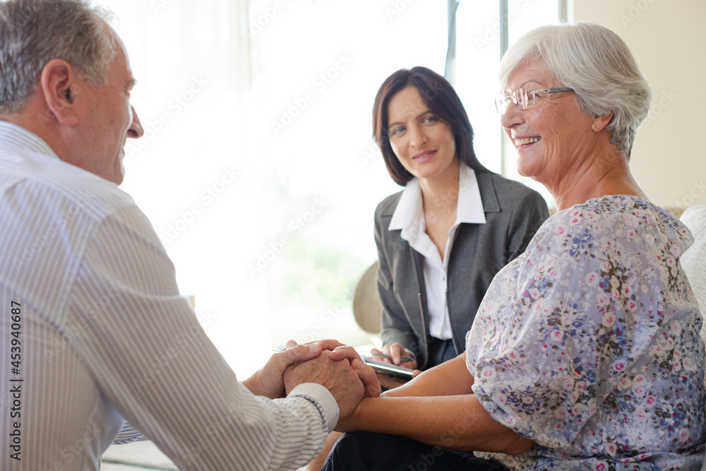 Fototapeta premium Financial advisor talking to couple on sofa