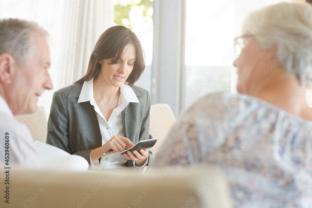 Financial advisor with couple on sofa Financial advisor with couple on sofa
