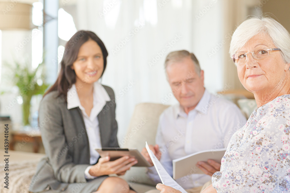 Financial advisor using tablet computer with clients Financial advisor using tablet computer with clients