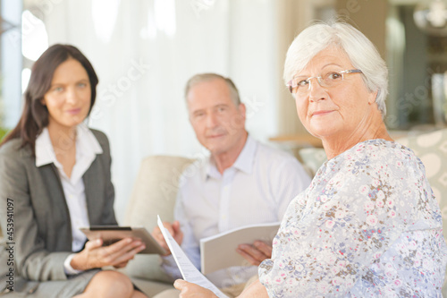 Financial advisor using tablet computer with clients