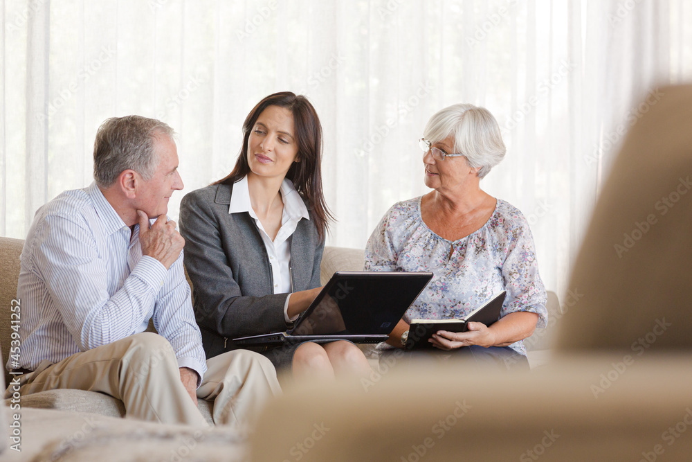 Financial advisor using tablet computer with clients Financial advisor using tablet computer with clients