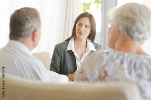 Financial advisor with couple on sofa