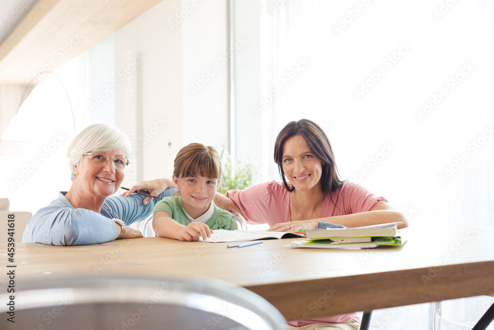 Mother and grandmother helping girl with homework Mother and grandmother helping girl with homework