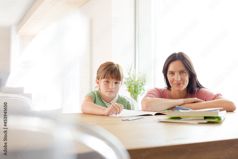 Mother helping daughter with homework
