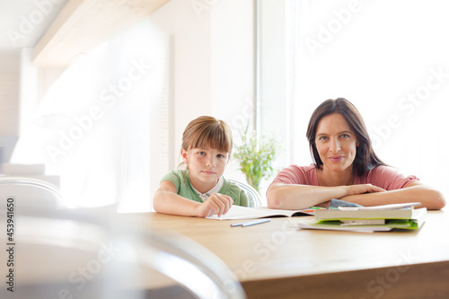 Mother helping daughter with homework © KOTO