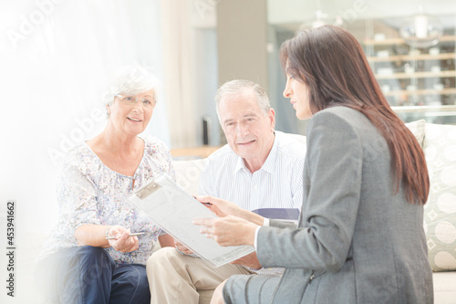 Financial advisor talking to couple on sofa