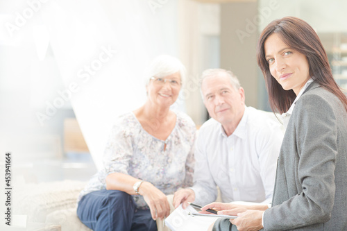 Financial advisor smiling with couple on sofa © KOTO
