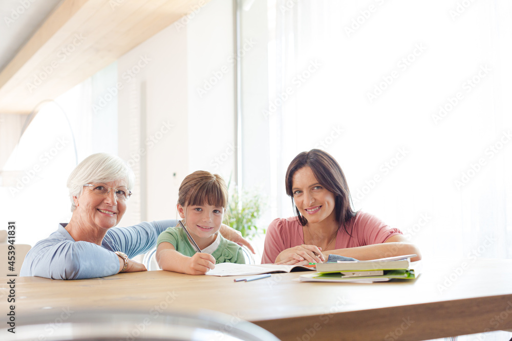 Mother and grandmother helping girl with homework Mother and grandmother helping girl with homework