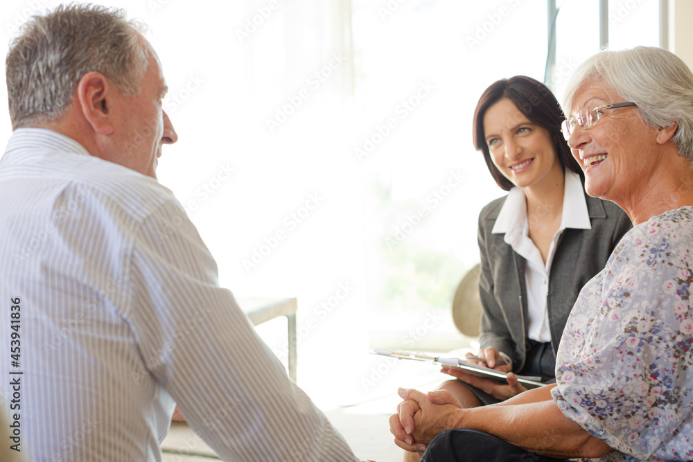 Fototapeta premium Financial advisor talking to couple on sofa