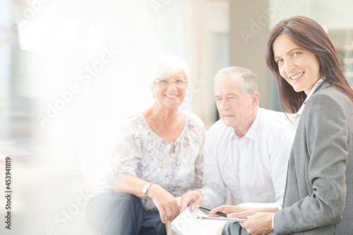 Financial advisor smiling with couple on sofa