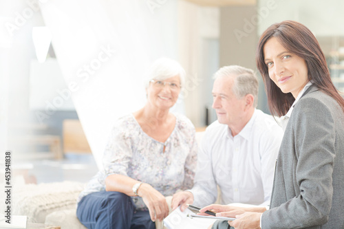 Financial advisor smiling with couple on sofa