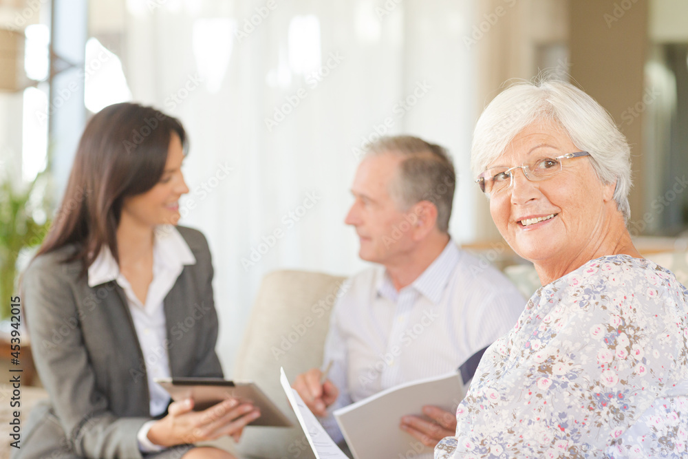 Financial advisor using tablet computer with clients Financial advisor using tablet computer with clients