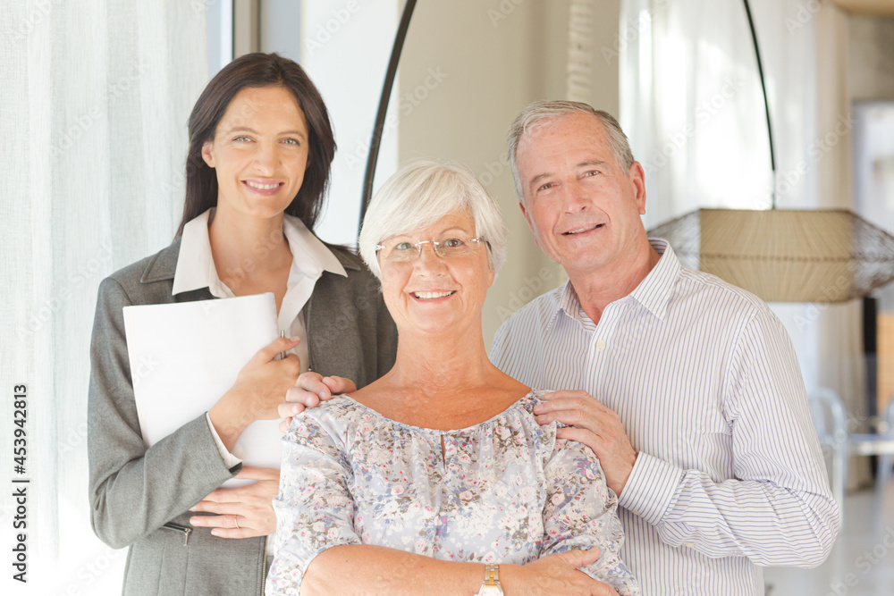 Financial advisor posing with clients Financial advisor posing with clients