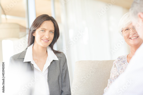 Financial advisor talking to couple on sofa