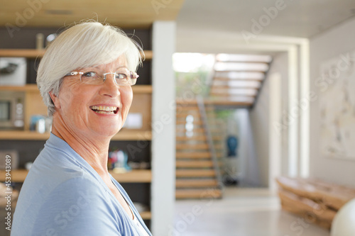 Older woman posing in modern house