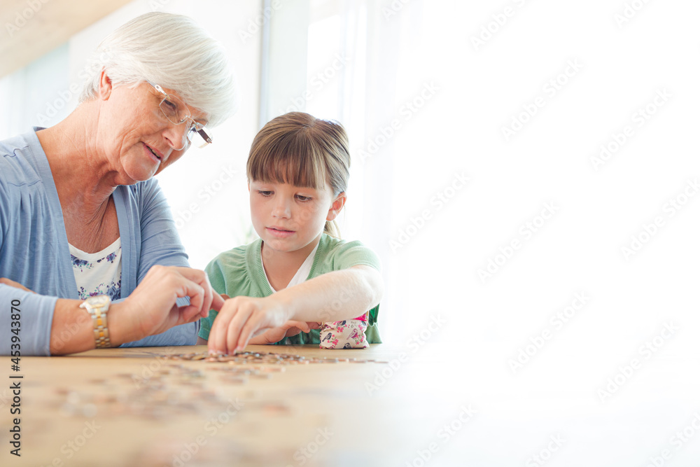 Older woman and granddaughter counting pennies Older woman and granddaughter counting pennies