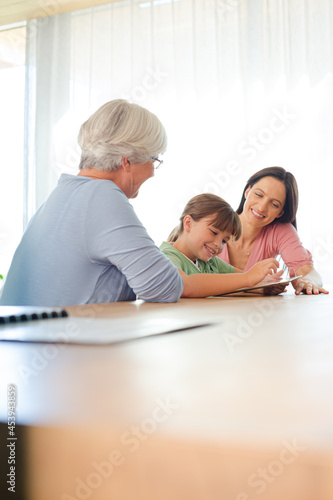 Three generations of women using tablet computer