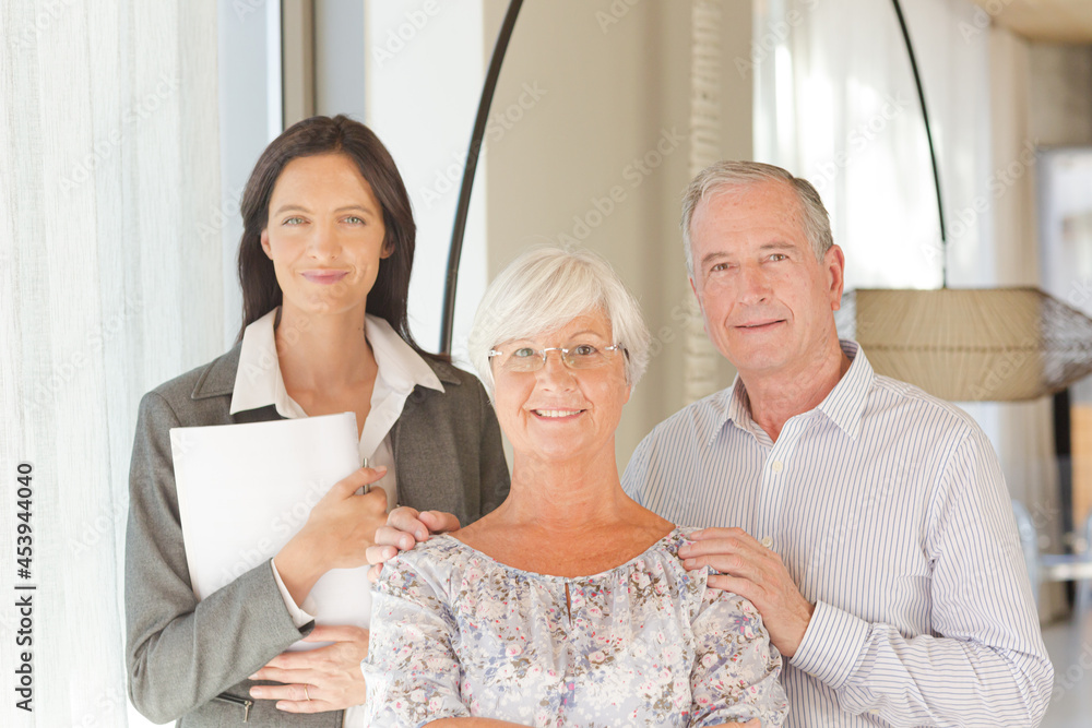 Financial advisor posing with clients Financial advisor posing with clients