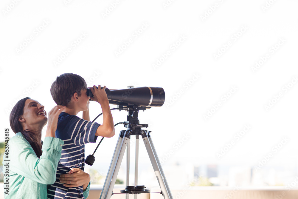Mother and son using telescope Mother and son using telescope