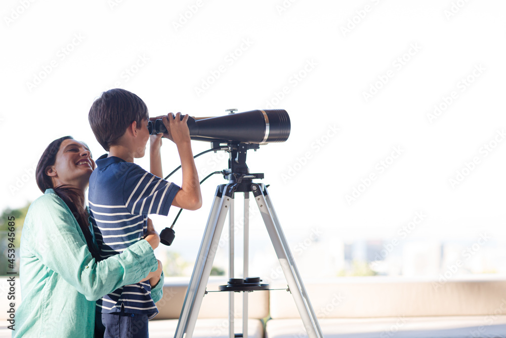 Mother and son using telescope Mother and son using telescope