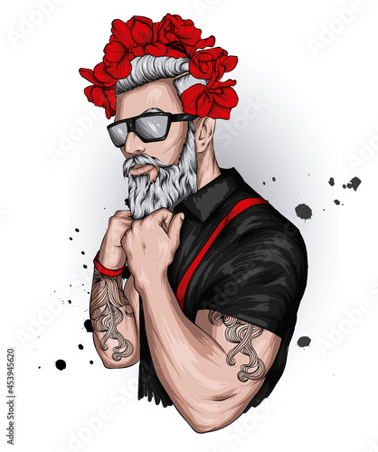 Handsome guy in stylish clothes and a floral wreath. Fashion and style, hipster and tattoo.