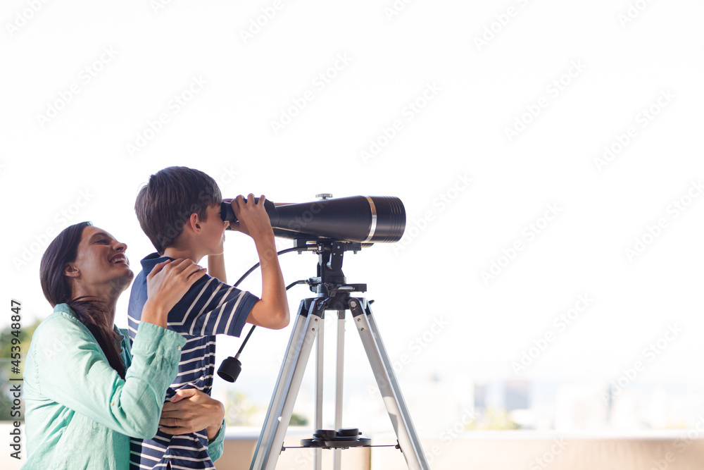 Mother and son using telescope Mother and son using telescope