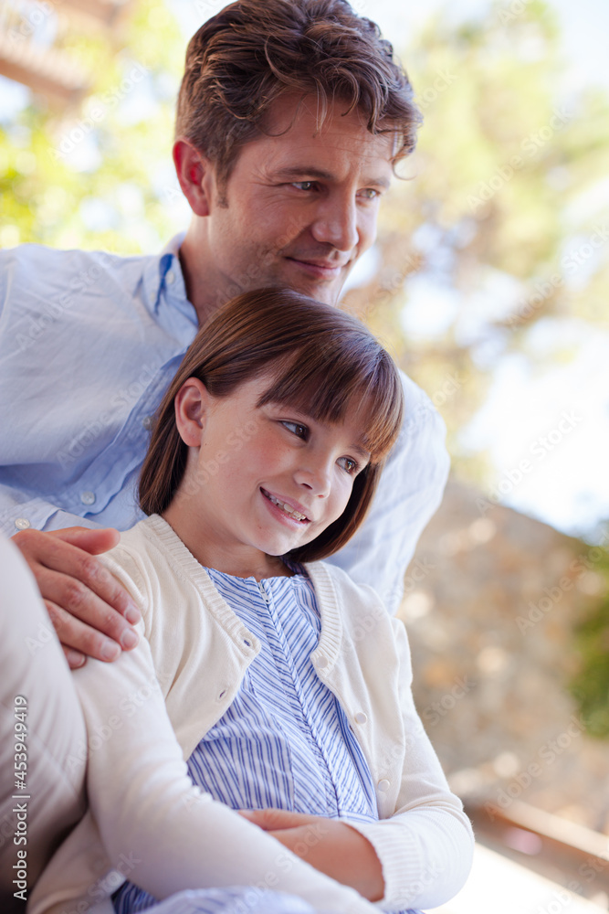 Father and daughter outdoors, smiling Father and daughter outdoors, smiling