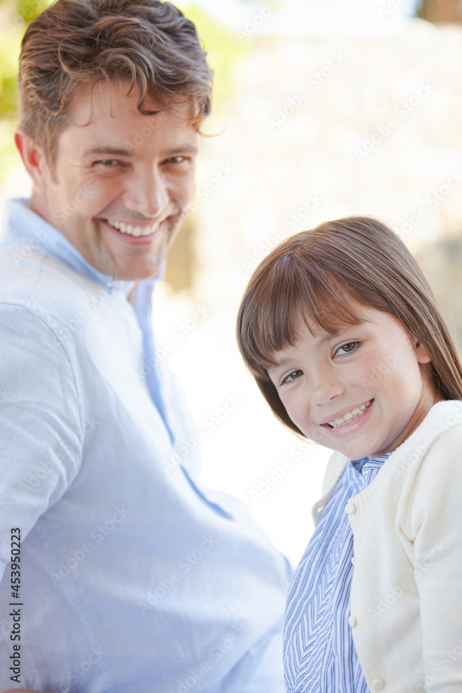 Fototapeta premium Father and daughter smiling outdoors