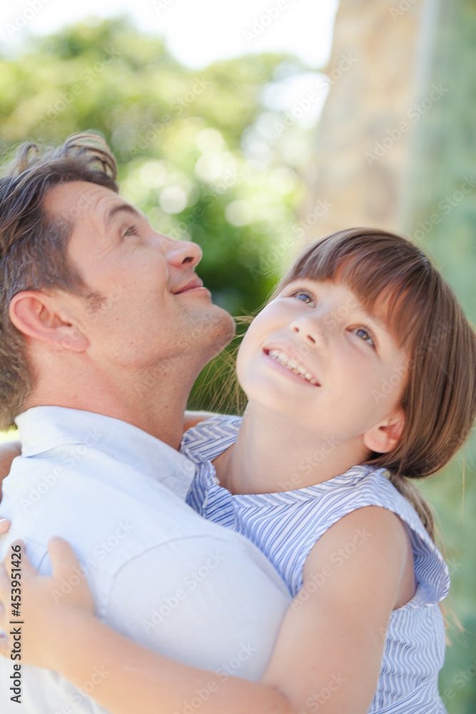 Father and daughter hugging outdoors Father and daughter hugging outdoors