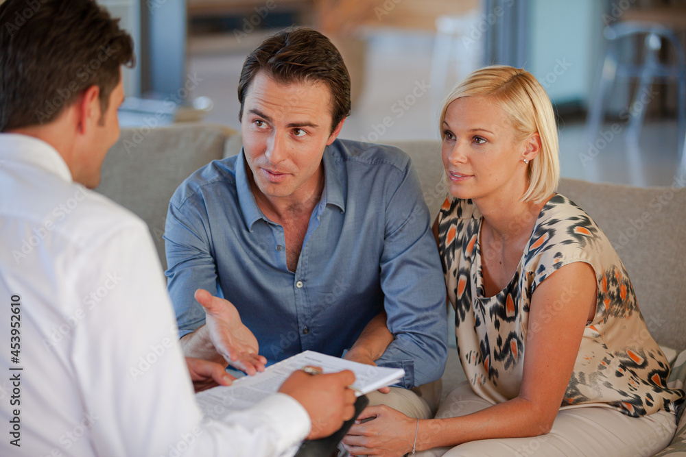 Fototapeta premium Financial advisor talking to couple on sofa