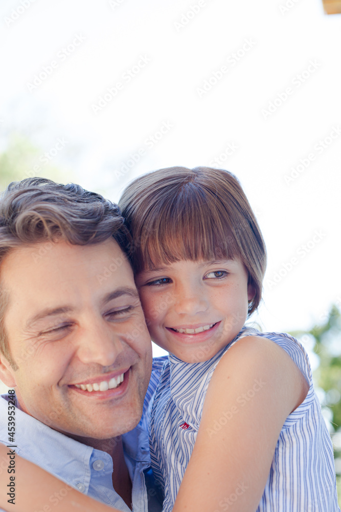 Father and daughter hugging outdoors Father and daughter hugging outdoors