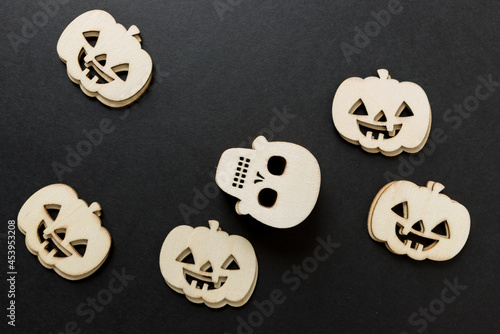 halloween theme with wooden shapes arranged on a black paper background