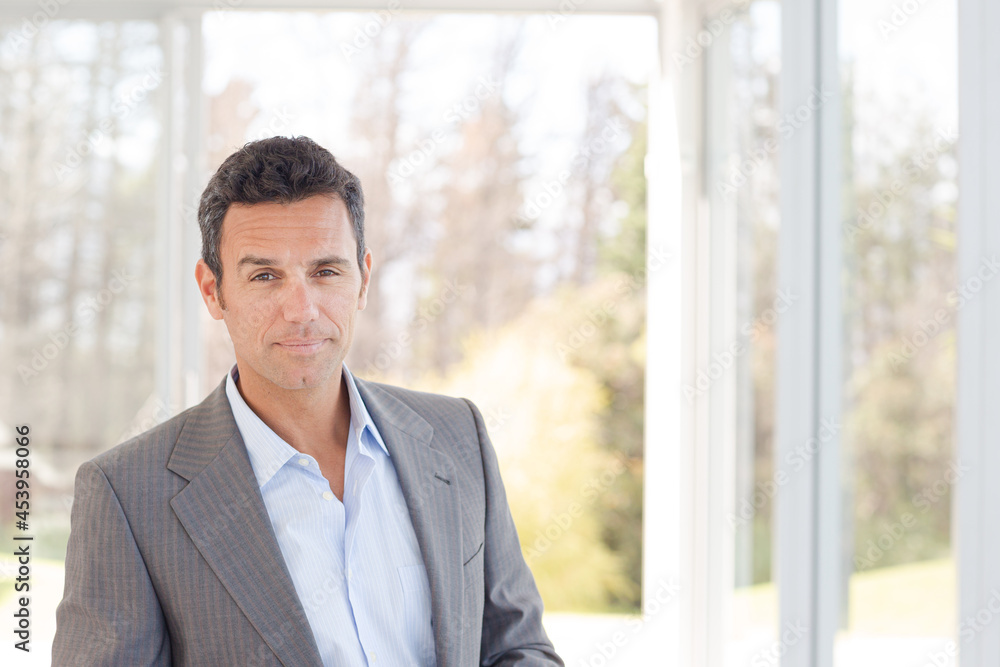 Businessman standing at office window Businessman standing at office window