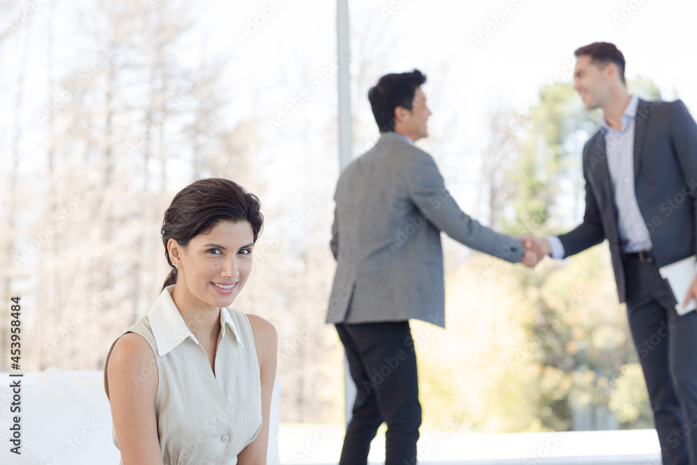 Businessmen shaking hands in office
