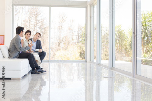 Business people talking on sofa in office Free Download Business people talking on sofa in office - GFXLoad