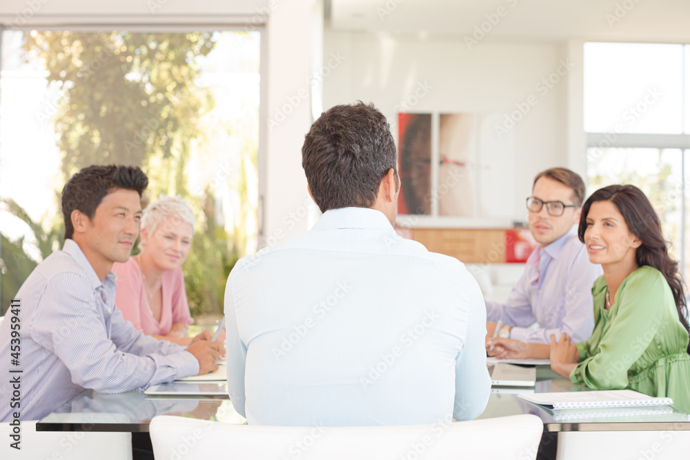Business people smiling in meeting Business people smiling in meeting