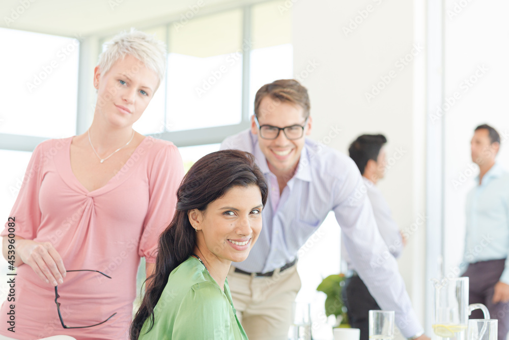 Business people smiling together in office Business people smiling together in office
