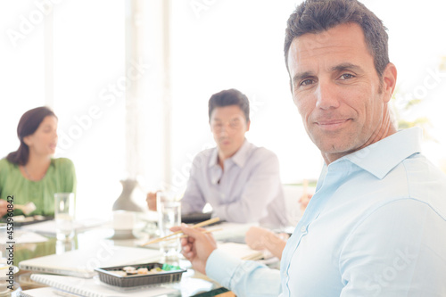 Businessman smiling in lunch meeting
