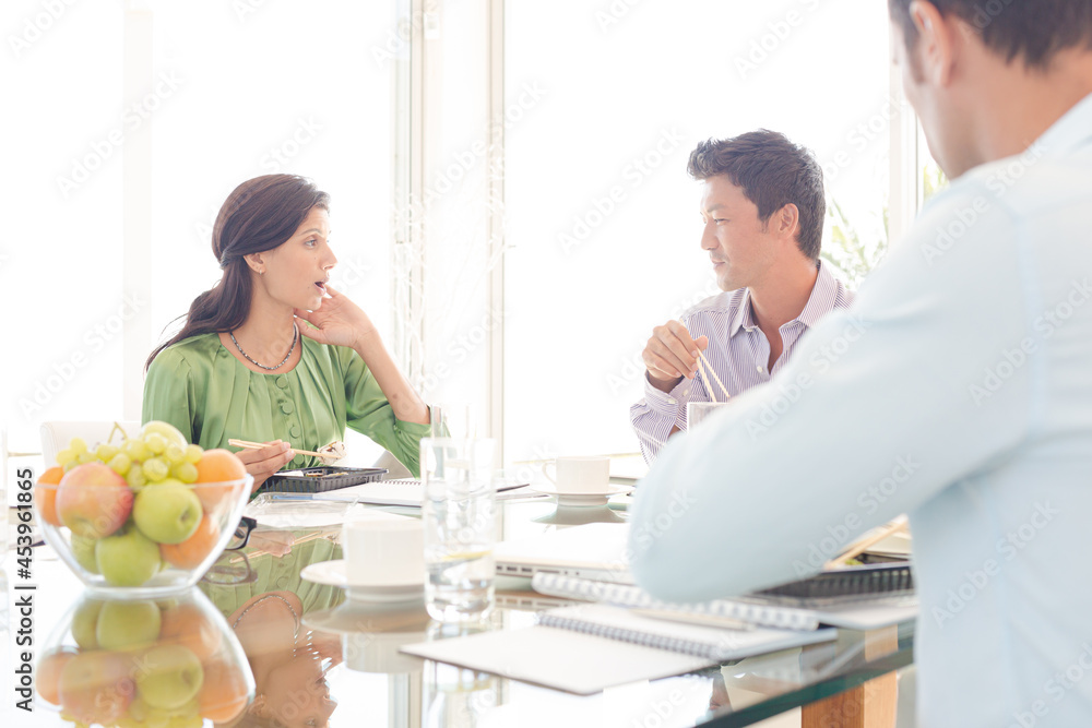 Business people smiling in lunch meeting Business people smiling in lunch meeting