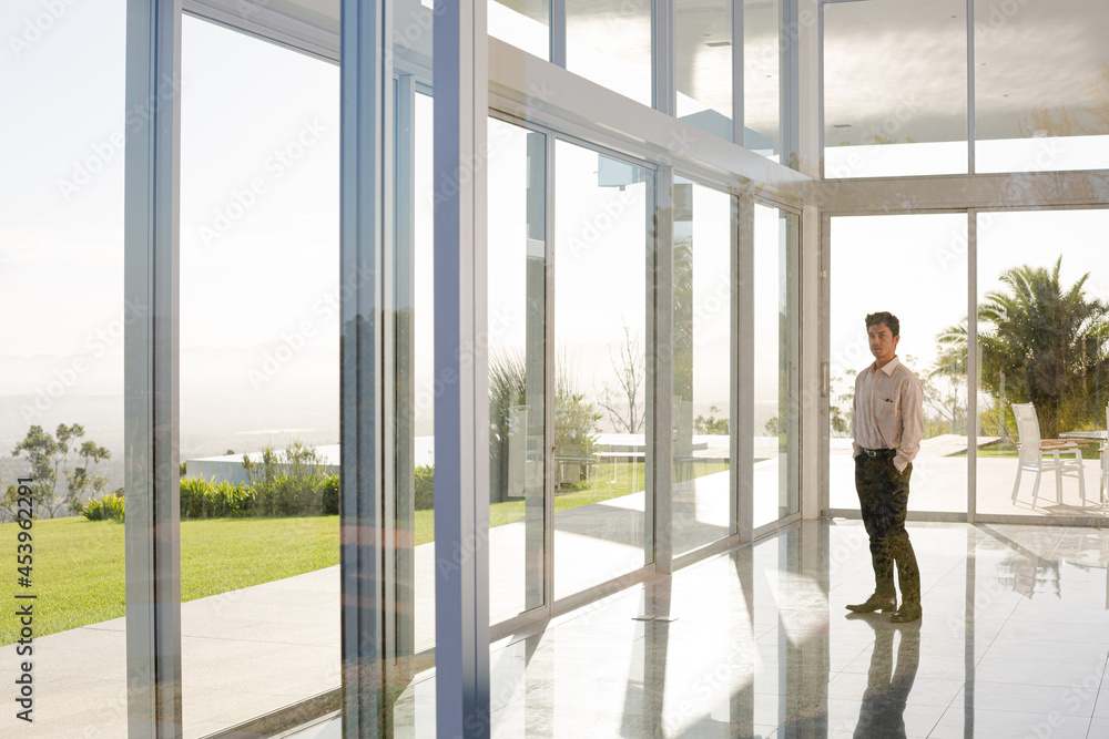 Businessman standing at office window Businessman standing at office window