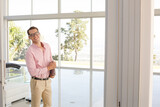 Businessman standing at office window