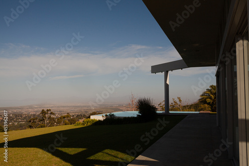 Modern house casting shadows on manicured lawn