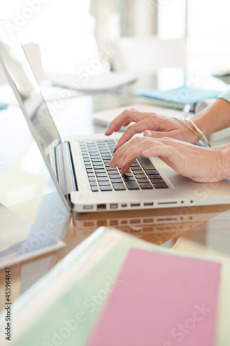 Businesswoman using laptop at desk