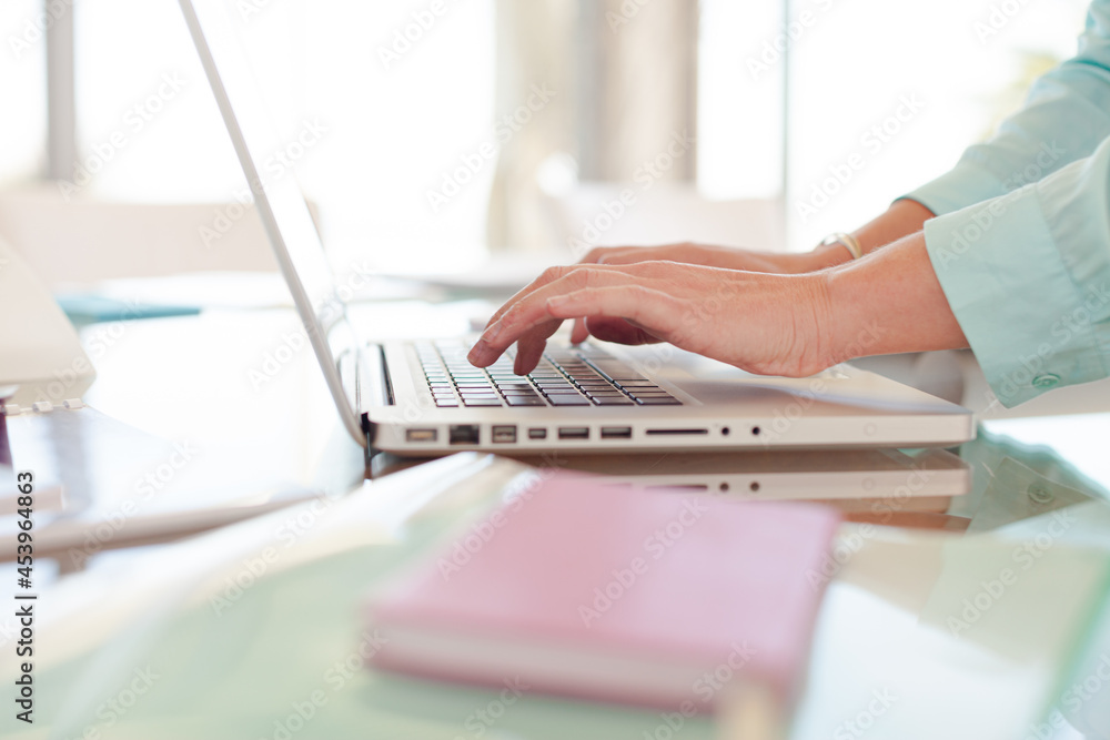 Businesswoman using laptop at desk Businesswoman using laptop at desk