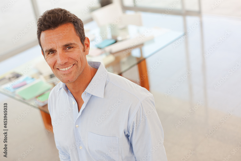 Businessman smiling in office Businessman smiling in office