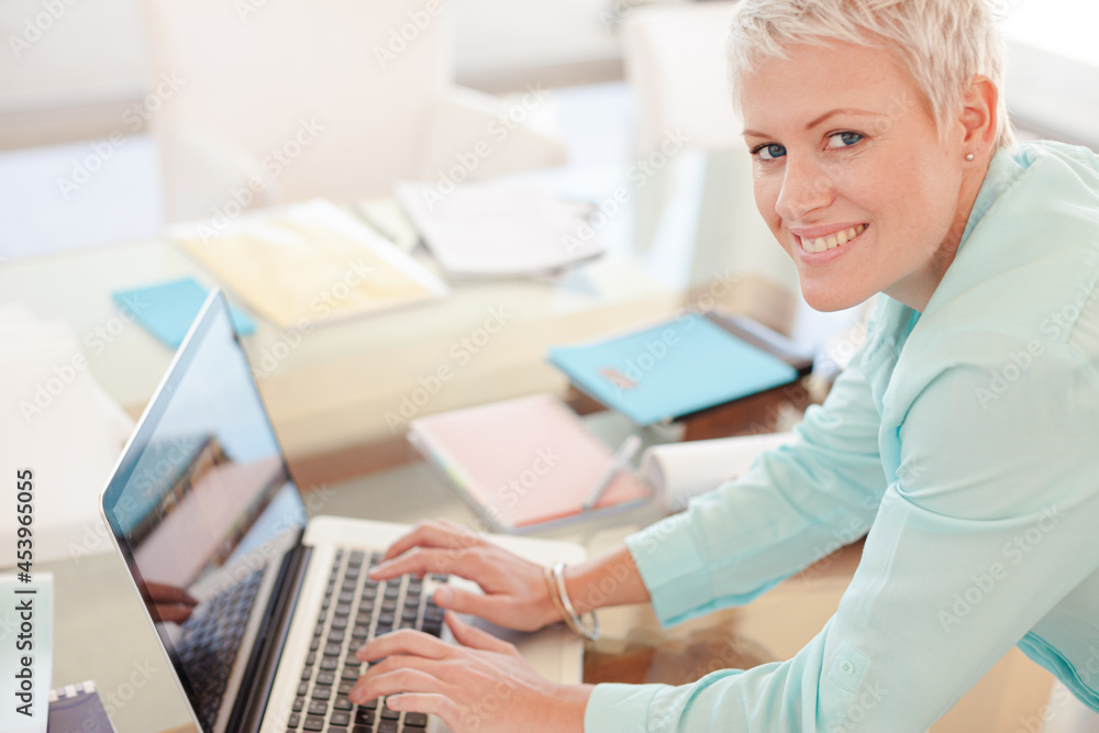 Businesswoman using laptop at desk Businesswoman using laptop at desk