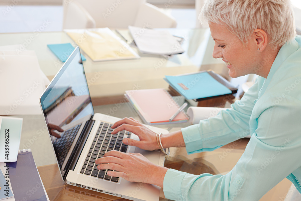 Businesswoman using laptop at desk Businesswoman using laptop at desk