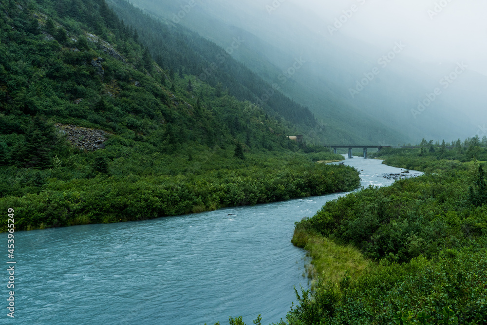 Fototapeta premium foggy mountain landscape with a bridge and beautiful river