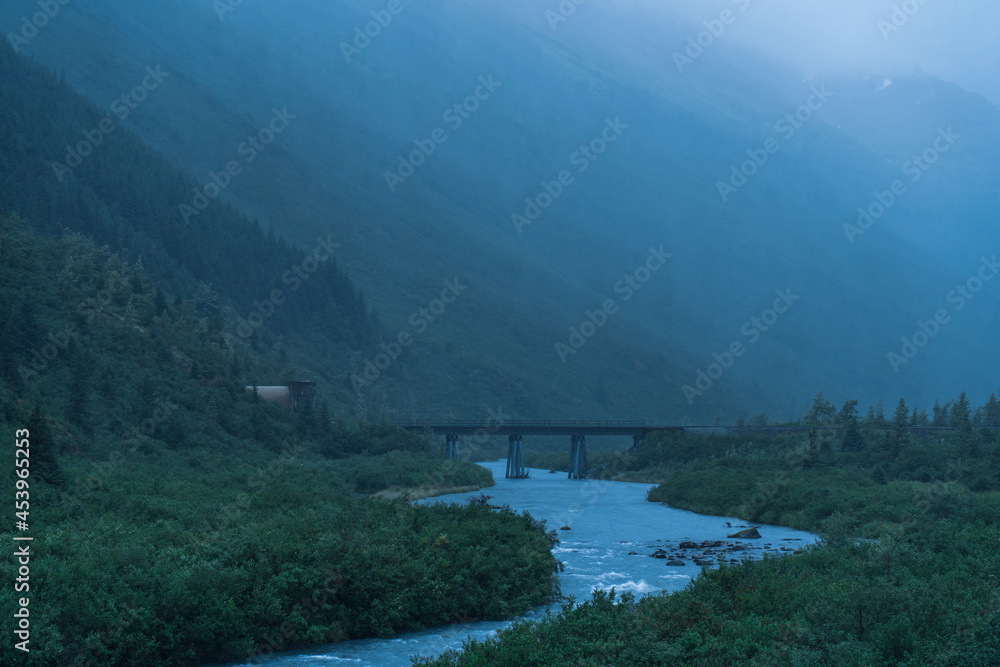 foggy mountain landscape with a bridge and beautiful river